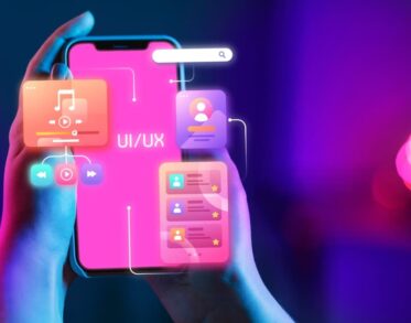 a hand holding a smartphone with colorful UI/UX design interface elements floating above